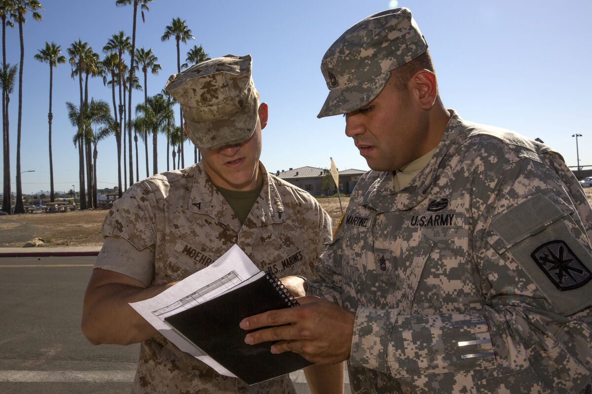 Investigators reviewing collision documentation and measurements at a roadway accident scene