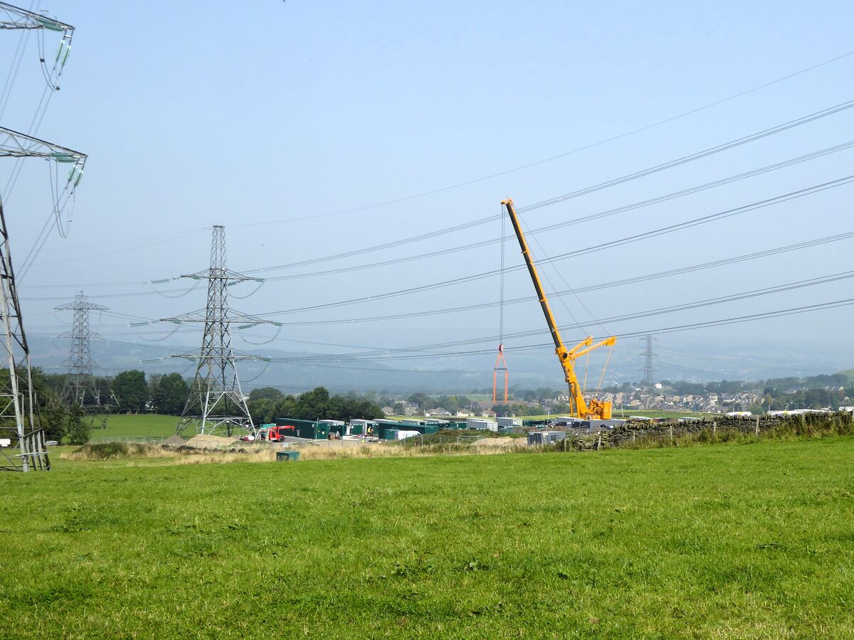 Construction crane and active site showing monitoring need
