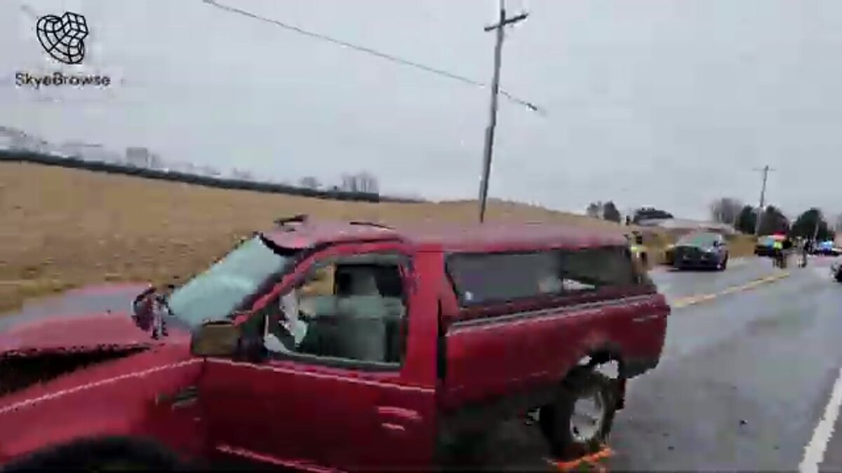 Drone video frame of a crash scene with a red truck on the road, captured for a SkyeBrowse 3D model