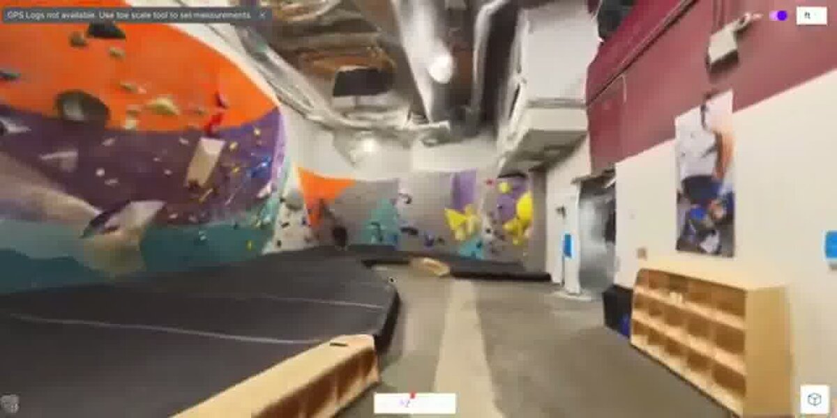 3D model walkthrough of an indoor climbing gym bouldering wall area, generated from a single 360 video, shown in a viewer with measurement toolbar