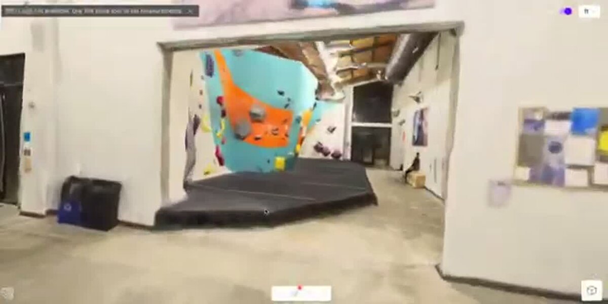 3D model walkthrough of an indoor climbing gym interior, generated from a single 360 video, shown in a viewer with measurement toolbar