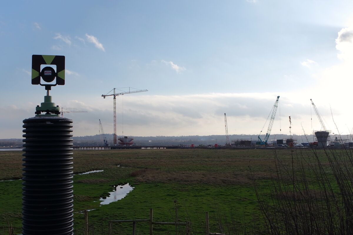 Survey equipment in use at an active construction site for progress documentation
