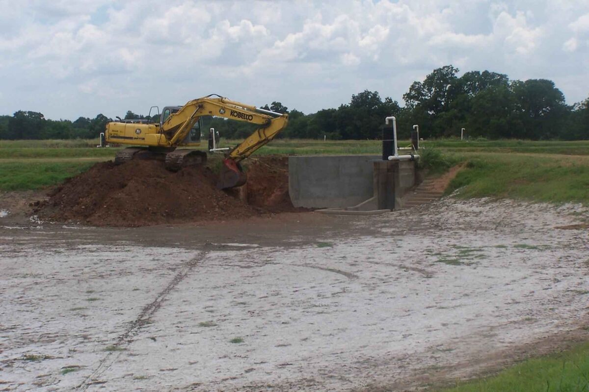 Excavator performing earth digging and grading work on an active construction site