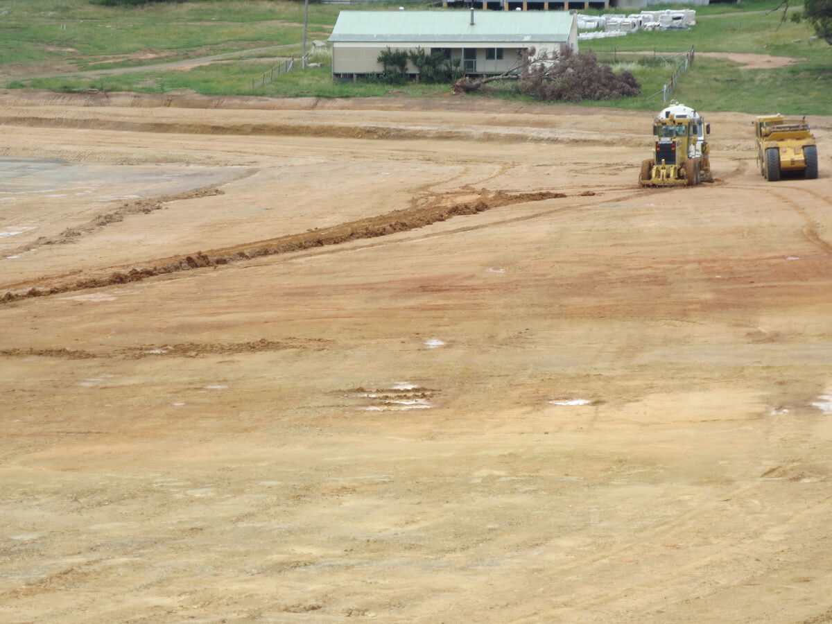 Construction site cleared and graded with bulldozer and heavy equipment for residential development