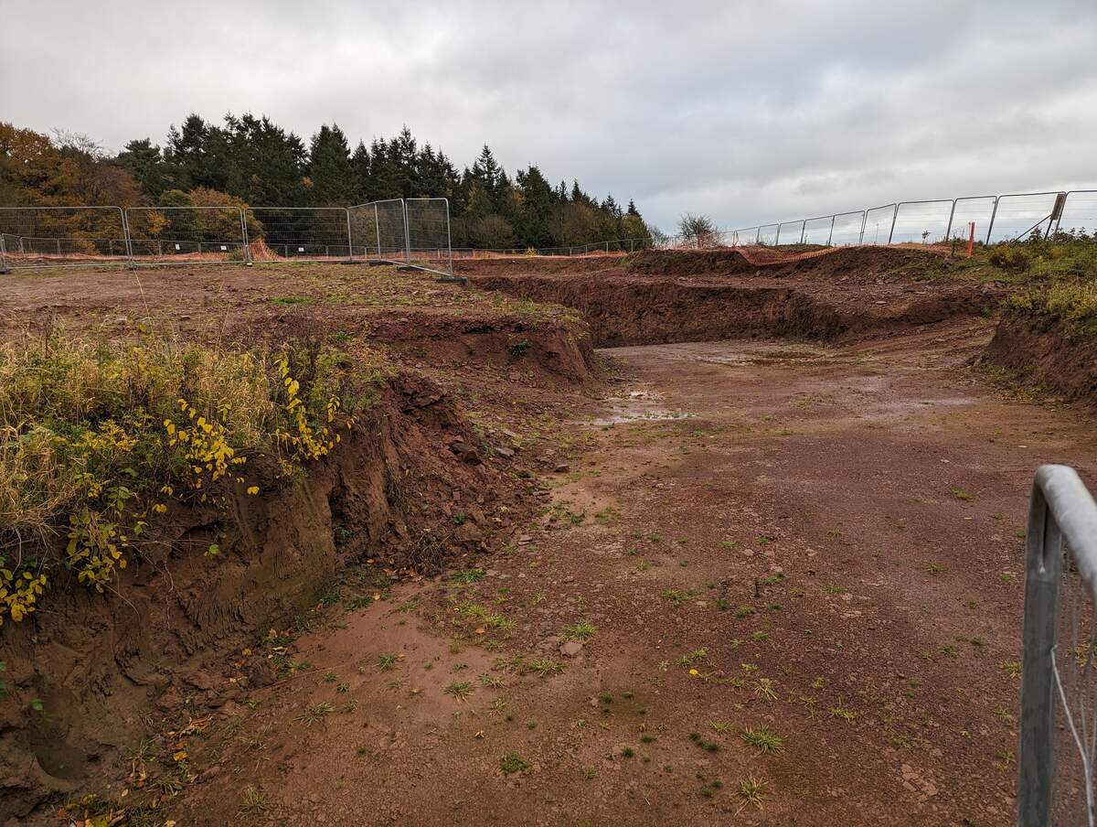 Earthworks excavation showing cut slopes and graded surfaces at an active construction site