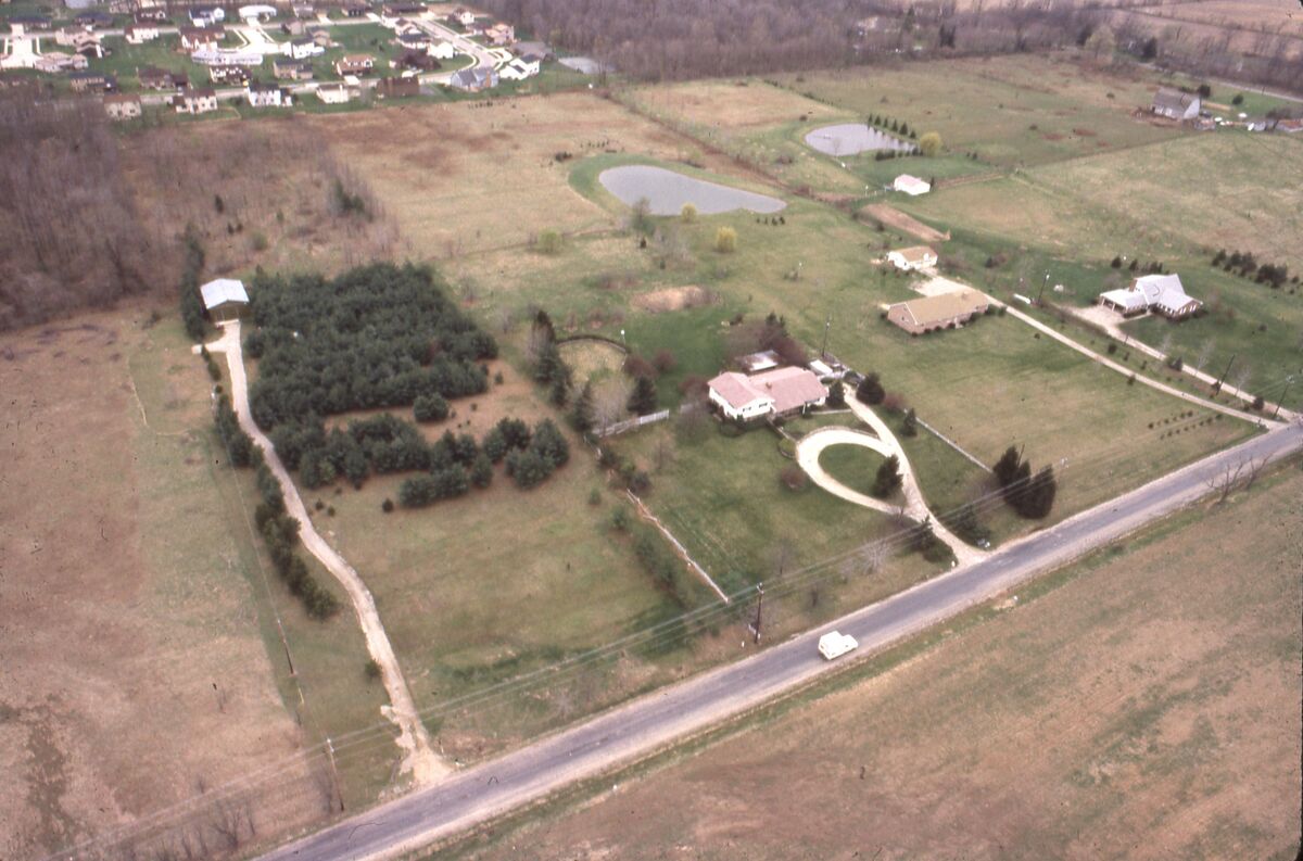 Aerial view of suburban neighborhood rooftops for HOA property compliance documentation
