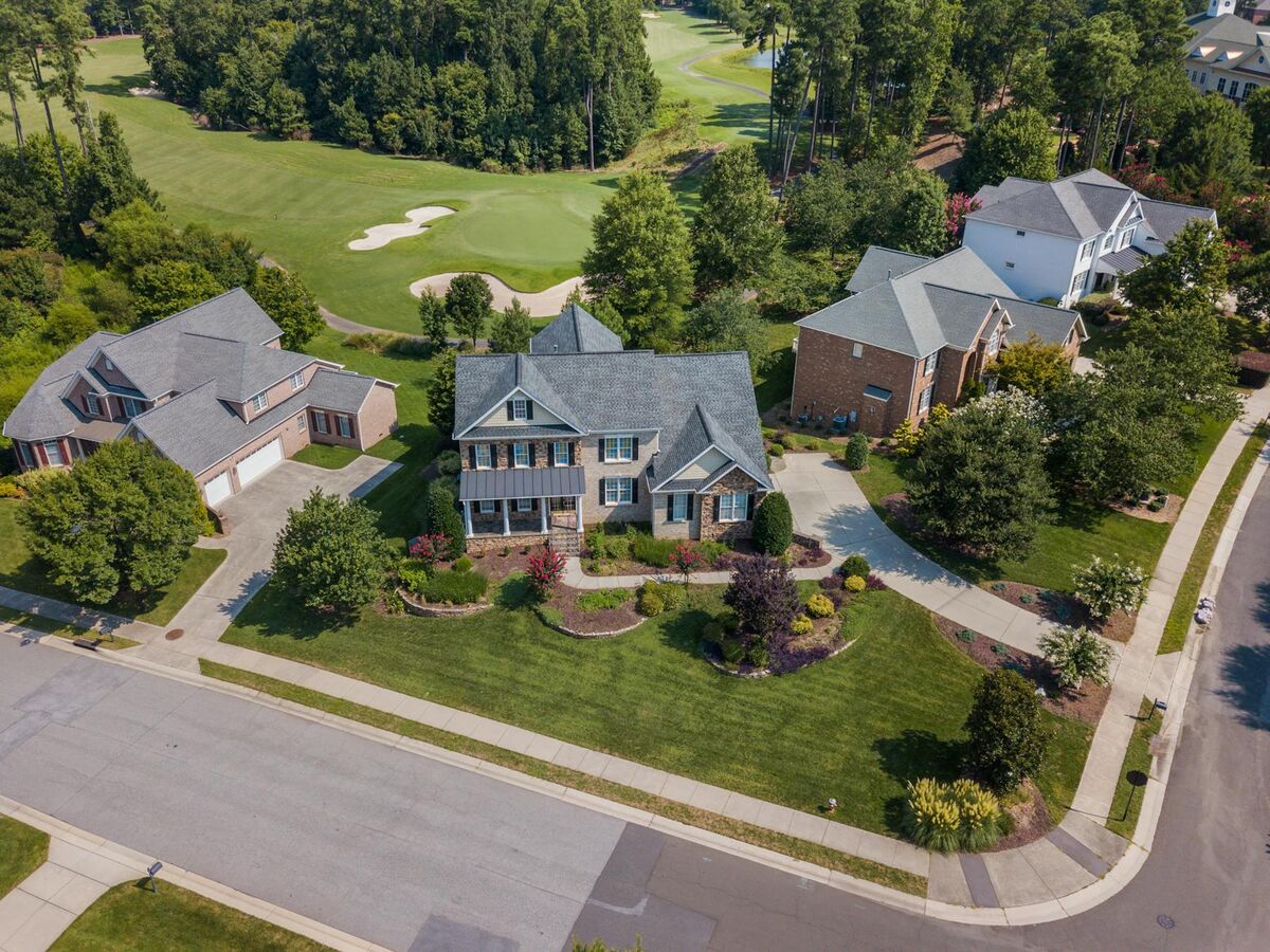 Aerial drone view of residential neighborhood showing rooftops and common areas