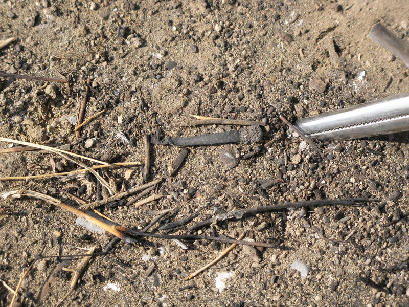 Fire investigation scene showing evidence documentation at origin and cause determination