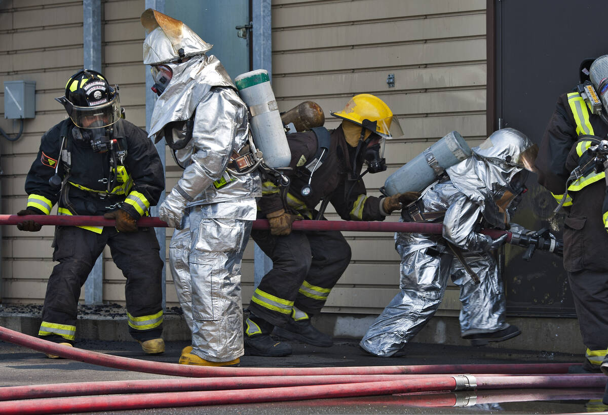 Firefighters entering a building during pre-incident training exercise, fire department operations
