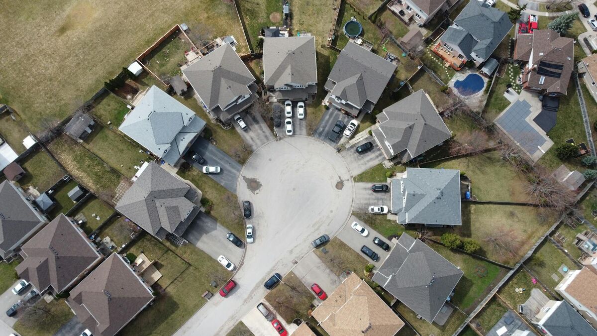 Aerial drone photograph of a suburban neighborhood showing modern residential homes for real estate marketing
