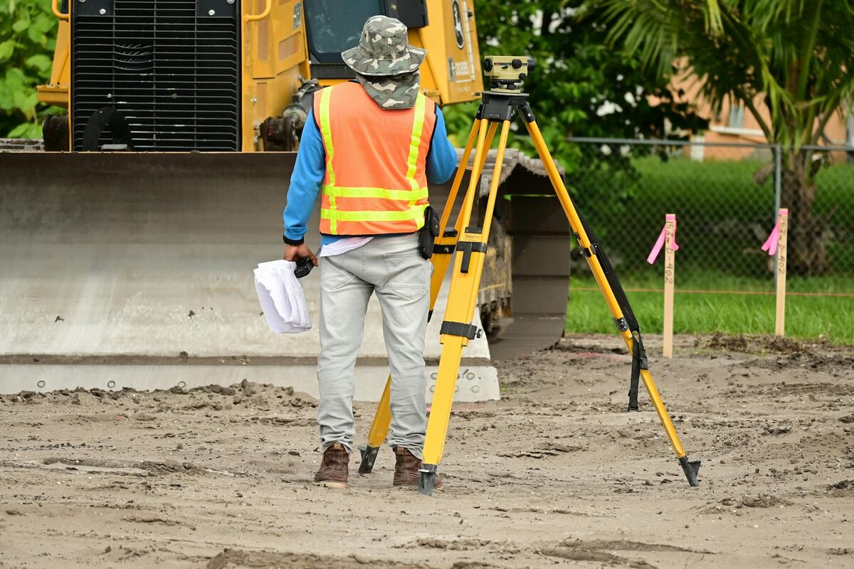 Surveyor with GPS equipment at a construction site
