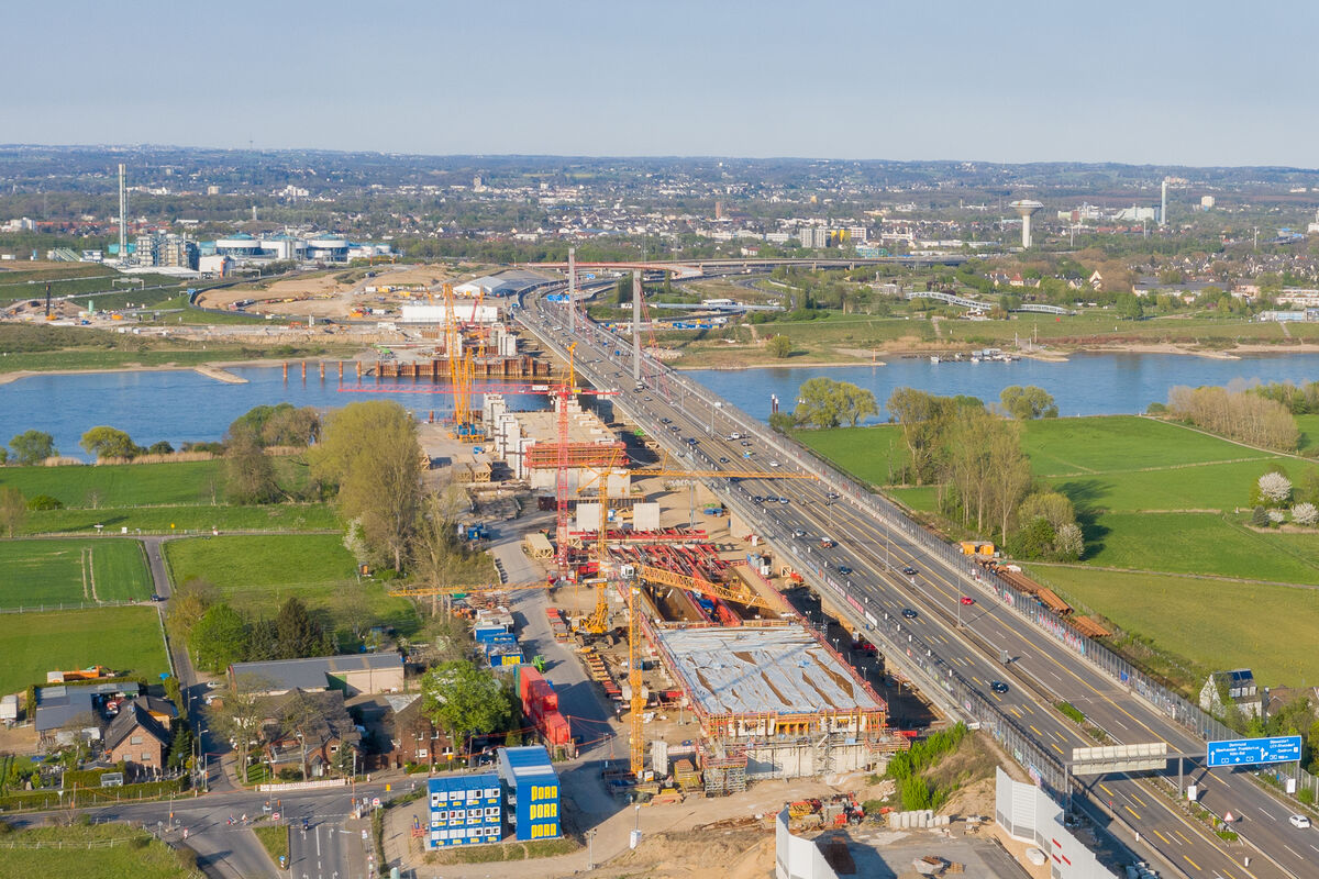 Aerial construction site documentation showing bridge construction progress over a river