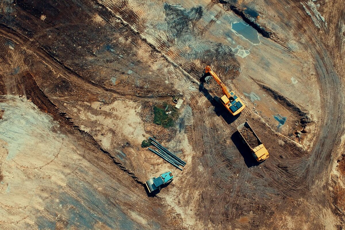 Aerial drone view of large active construction site with multiple structures under development