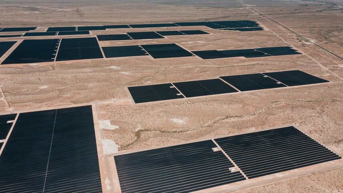 Aerial view of a large solar farm from drone altitude showing rows of photovoltaic panels